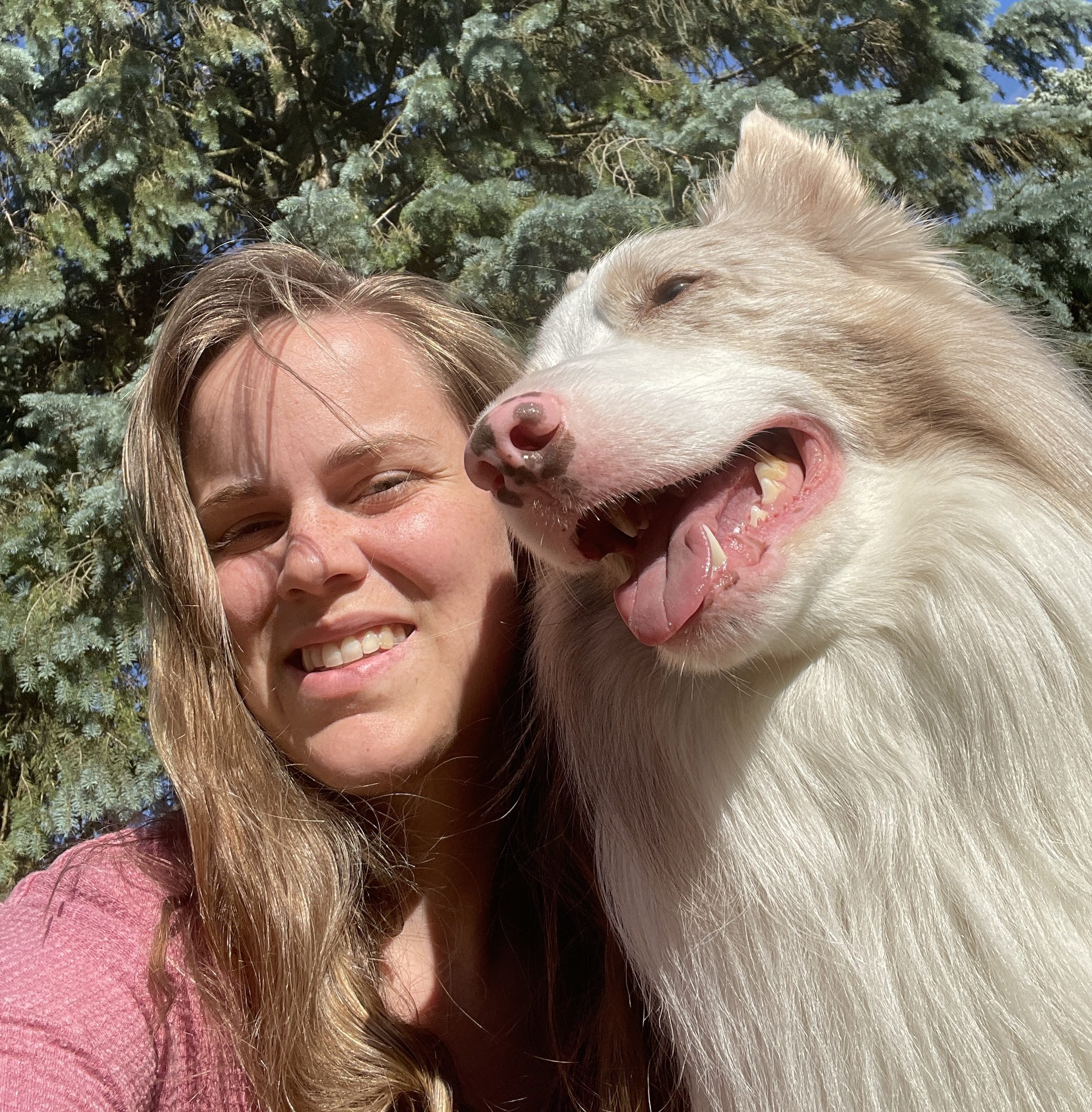 The Grand Rapids dog trainer, Alaina, and her dog Arlo pose outside